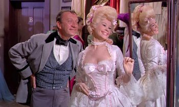 Movie still from “Frankie and Johnny” (1966), directed by Frederick De Cordova – A man standing next to a woman in a white dress; Medium shot, Low angle