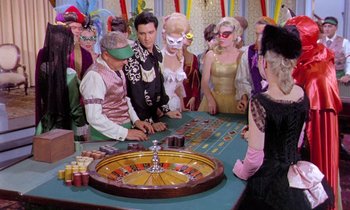 Movie still from “Frankie and Johnny” (1966), directed by Frederick De Cordova – A group of people standing around a roulette table; Wide shot, High angle
