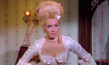 Movie still from “Frankie and Johnny” (1966), directed by Frederick De Cordova – A woman in a white dress with a long blonde wig; Medium shot, Over the shoulder angle