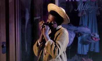 Movie still from “Frankie and Johnny” (1966), directed by Frederick De Cordova – A person wearing a straw hat holding a cell phone; Medium shot, High angle
