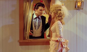 Movie still from “Frankie and Johnny” (1966), directed by Frederick De Cordova – A man and a woman dressed up as elvis and marie antoinette looking at each other; Medium shot, Over the shoulder angle