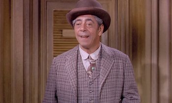 Movie still from “Frankie and Johnny” (1966), directed by Frederick De Cordova – An older man wearing a hat and a suit; Medium shot, Over the shoulder angle