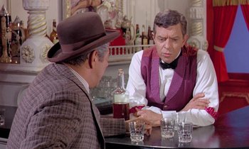 Movie still from “Frankie and Johnny” (1966), directed by Frederick De Cordova – Two men sitting at a table in front of drinks; Medium shot, Over the shoulder angle