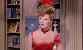 Movie still from “Frankie and Johnny” (1966), directed by Frederick De Cordova – A woman in a red dress with a red flower in her hair; Close Up shot, Over the shoulder angle