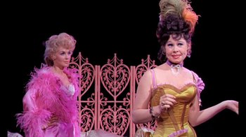 Movie still from “Frankie and Johnny” (1966), directed by Frederick De Cordova – Two women dressed in pink and a yellow dress; Medium shot, Low angle