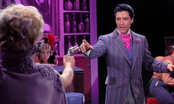 Movie still from “Frankie and Johnny” (1966), directed by Frederick De Cordova – A man holding a gun in front of two women; Medium shot, Over the shoulder angle