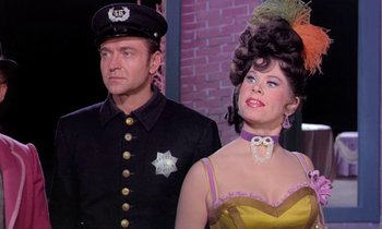 Movie still from “Frankie and Johnny” (1966), directed by Frederick De Cordova – A man and a woman dressed as police officers; Medium shot, Low angle