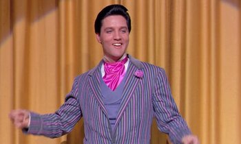 Movie still from “Frankie and Johnny” (1966), directed by Frederick De Cordova – A wax figure of elvis presley is shown in a suit; Medium shot, Low angle