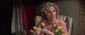 Movie still from “Funny Lady” (1975), directed by Herbert Ross – A woman sitting in a chair holding a phone; Close Up shot, High angle