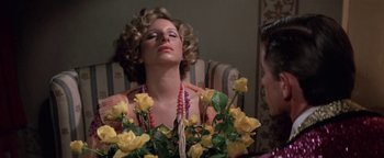 Movie still from “Funny Lady” (1975), directed by Herbert Ross – A woman sitting in a chair with a bouquet of yellow roses; Close Up shot, High angle