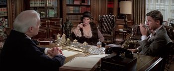 Movie still from “Funny Lady” (1975), directed by Herbert Ross – A woman sitting at a table talking on a phone; Medium shot, High angle