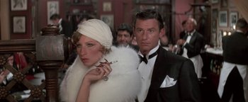 Movie still from “Funny Lady” (1975), directed by Herbert Ross – A man and a woman dressed in a white dress and black suit; Close Up shot, High angle