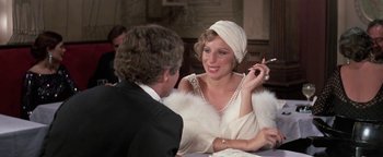 Movie still from “Funny Lady” (1975), directed by Herbert Ross – A man and a woman sitting at a dinner table talking to each other; Close Up shot, Over the shoulder angle