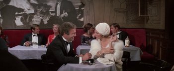 Movie still from “Funny Lady” (1975), directed by Herbert Ross – A man and a woman sitting at a dinner table; Medium shot, Over the shoulder angle