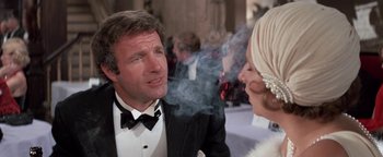 Movie still from “Funny Lady” (1975), directed by Herbert Ross – A man and a woman in formal wear talking to each other; Close Up shot, Over the shoulder angle