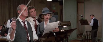 Movie still from “Funny Lady” (1975), directed by Herbert Ross – A man and a woman are reading a sheet of paper; Medium shot, High angle