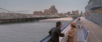 Movie still from “Funny Lady” (1975), directed by Herbert Ross – A man and a woman standing next to each other on a bridge; Wide shot, High angle