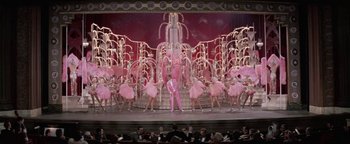 Movie still from “Funny Lady” (1975), directed by Herbert Ross – A group of people on a stage performing a show; Extreme Wide shot, High angle