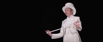 Movie still from “Funny Lady” (1975), directed by Herbert Ross – A woman in a top hat holding a white cane; Medium shot, Low angle