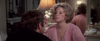 Movie still from “Funny Lady” (1975), directed by Herbert Ross – A woman smoking a cigarette in front of a man; Close Up shot, Over the shoulder angle
