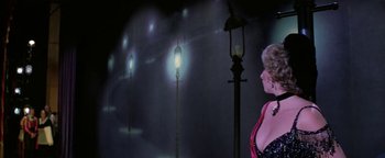 Movie still from “Funny Lady” (1975), directed by Herbert Ross – A woman standing next to a street light; Medium shot, Low angle