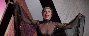 Movie still from “Funny Lady” (1975), directed by Herbert Ross – A woman wearing a black dress and a silver headpiece; Close Up shot, Low angle