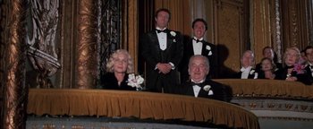 Movie still from “Funny Lady” (1975), directed by Herbert Ross – A group of people in tuxedos sitting at a table; Wide shot, Low angle