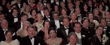 Movie still from “Funny Lady” (1975), directed by Herbert Ross – A large group of people in formal attire; Medium shot, High angle