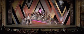 Movie still from “Funny Lady” (1975), directed by Herbert Ross – A group of people on a stage performing a dance; Extreme Wide shot, High angle