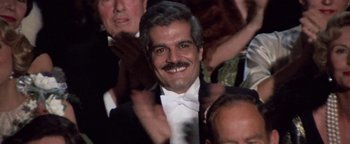 Movie still from “Funny Lady” (1975), directed by Herbert Ross – A person wearing a suit and a bow tie; Close Up shot, Low angle