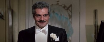 Movie still from “Funny Lady” (1975), directed by Herbert Ross – A person wearing a suit and a bow tie; Close Up shot, Low angle