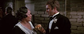 Movie still from “Funny Lady” (1975), directed by Herbert Ross – A man and a woman holding a gift box; Close Up shot, Over the shoulder angle