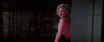 Movie still from “Funny Lady” (1975), directed by Herbert Ross – A woman in a black dress is posing for a picture; Close Up shot, Low angle