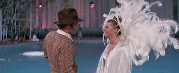 Movie still from “Funny Lady” (1975), directed by Herbert Ross – A man and a woman are dressed up for a costume party; Medium shot, Over the shoulder angle