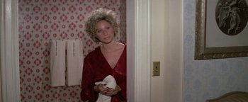 Movie still from “Funny Lady” (1975), directed by Herbert Ross – A woman standing in a bathroom holding a towel; Medium shot, High angle