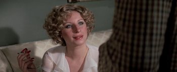 Movie still from “Funny Lady” (1975), directed by Herbert Ross – A person sitting on a couch near a window; Close Up shot, Over the shoulder angle