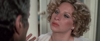 Movie still from “Funny Lady” (1975), directed by Herbert Ross – A person with curly blonde hair; Close Up shot, Over the shoulder angle