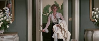 Movie still from “Funny Lady” (1975), directed by Herbert Ross – A woman holding a pair of scissors in her hand; Medium shot, High angle