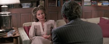Movie still from “Funny Lady” (1975), directed by Herbert Ross – An older woman sitting on a couch talking to a man; Medium shot, Over the shoulder angle