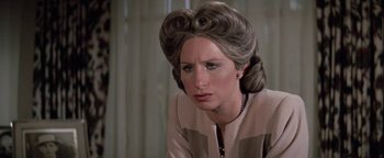 Movie still from “Funny Lady” (1975), directed by Herbert Ross – An older woman wearing a wig looking sad; Close Up shot, Over the shoulder angle