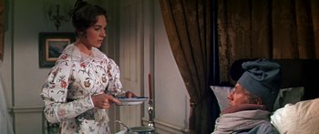 Movie still from “Hawaii” (1966), directed by George Roy Hill – A woman holding a plate in her hands; Medium shot, Over the shoulder angle