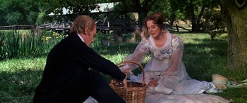 Movie still from “Hawaii” (1966), directed by George Roy Hill – A man and a woman sitting on the ground with a basket; Medium shot, Over the shoulder angle