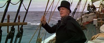 Movie still from “Hawaii” (1966), directed by George Roy Hill – A man in a top hat on a boat in the ocean; Medium shot, Low angle