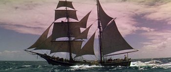 Movie still from “Hawaii” (1966), directed by George Roy Hill – A large sail boat sailing on the water; Wide shot, Low angle