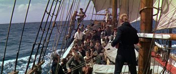 Movie still from “Hawaii” (1966), directed by George Roy Hill – A group of people sitting on top of a boat; Wide shot, High angle