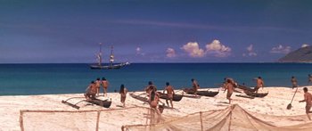 Movie still from “Hawaii” (1966), directed by George Roy Hill – A group of people in canoes on the beach; Extreme Wide shot, High angle