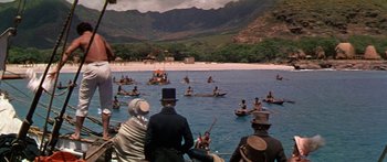 Movie still from “Hawaii” (1966), directed by George Roy Hill – A group of people on boats in a body of water; Extreme Wide shot, High angle