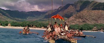 Movie still from “Hawaii” (1966), directed by George Roy Hill – A group of people on a raft in the water; Extreme Wide shot, High angle