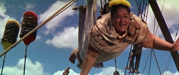 Movie still from “Hawaii” (1966), directed by George Roy Hill – An older woman hanging upside down on a swing; Medium shot, Low angle