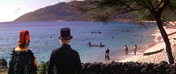 Movie still from “Hawaii” (1966), directed by George Roy Hill – A man in a top hat looks out over the water; Extreme Wide shot, High angle